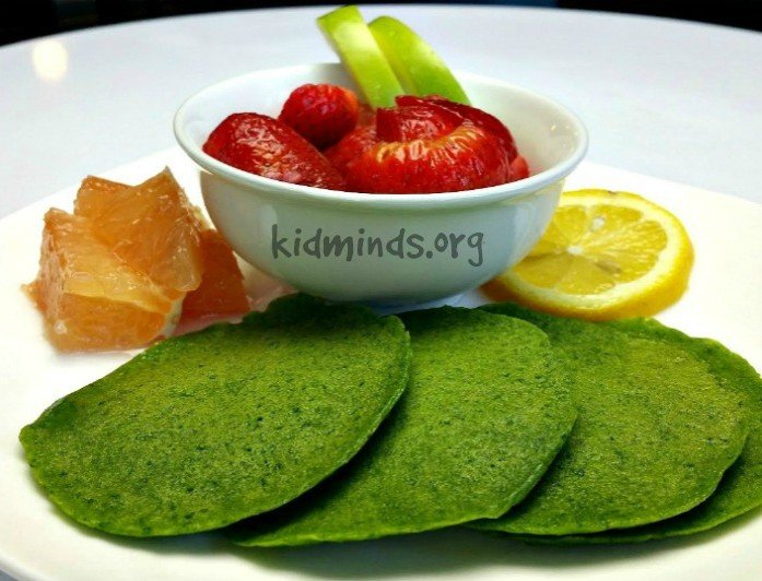 Green pancakes without artificial colorings.  The rich green color comes from fresh spinach. Perfect for St. Patrick's Day or any other day of the year!  #kidscook #handsonlearning #cookingwithkids #healthykids #kidsactivities #greenpancakes