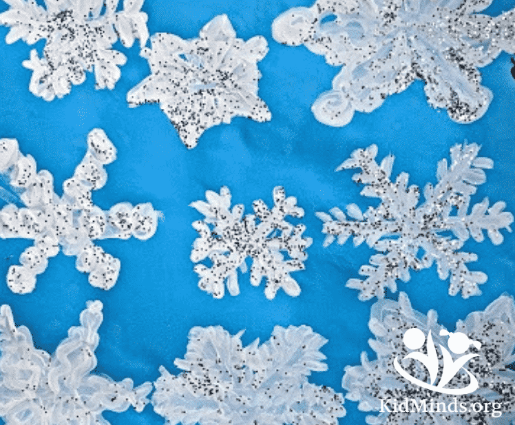 Transform your home into a winter wonderland with these glittery snowflakes. No real snow required. #winterart #snowflakes #art4kids