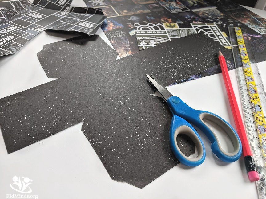 This fun project uses Star Wars-themed paper, a ruler, and a pencil to draw and create a 3-D cube that can be used for room decor, party favors, toys, or gifts. #craftykids #creativekids #handsonlearning #kidminds #earlyeducation #elementarymath #laughingkidslearn #freeprintable #StarWars #papercube